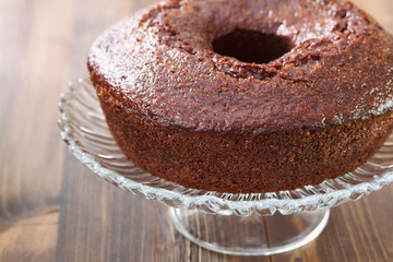 chocolated cake on dish on brown background