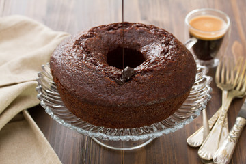 chocolated cake on dish on brown wooden background