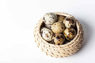 Fresh quail eggs at wooden plate closeup