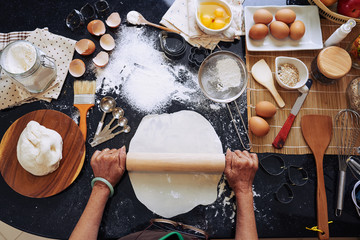 Senior woman making cookies, view from the top