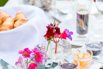 Delicious Breakfast with Fresh Flaky Croissants, Strawberry Jam and Tea in Restaurant