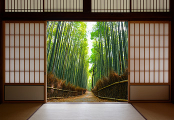 Travel background of Japanese rice paper doors opened to a peaceful bamboo forest path