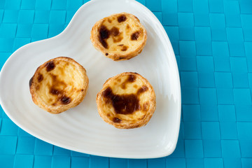 Three Portuguese Pastel de Nata on a Plate