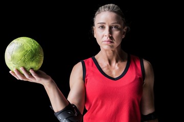 Female athlete with elbow pad holding handball - 117243618