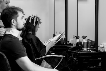 Man in hair doing salon. Black and white view. Waiting for hair cutting