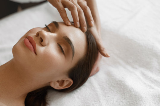 Spa Massage. Beautiful Woman Getting Facial Beauty Treatment
