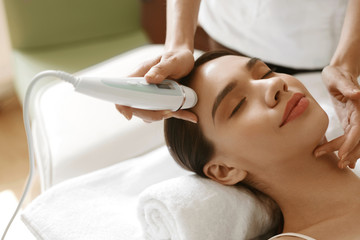 Skin Care. Women Analyzing Facial Skin With Analyzer. Beauty