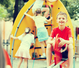 Fototapeta na wymiar cheerful boy on children's playground.