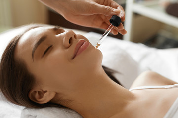 Obraz na płótnie Canvas Face Skin Care. Woman Receiving Serum Treatment In Beauty Salon