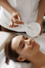 Skin Care. Beautiful Woman Getting Cosmetic Mask At Spa Salon