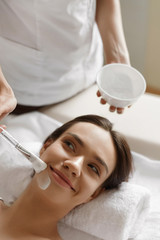 Obraz na płótnie Canvas Skin Care. Beautiful Woman Getting Cosmetic Mask At Spa Salon