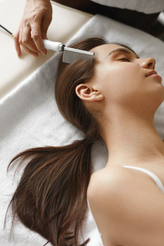 Brushing Beautiful Woman Long Hair. Hair Beauty Treatment