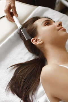 Hair Care. Beautiful Woman Receiving Brushing Beauty Treatment
