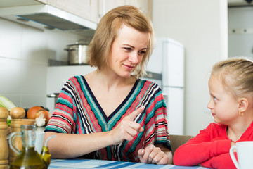 Upset mother shaming daughter