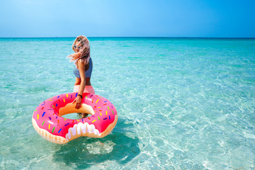 Woman with inflatable ring on beach