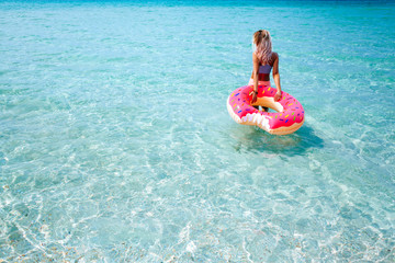 Woman with inflatable ring on beach