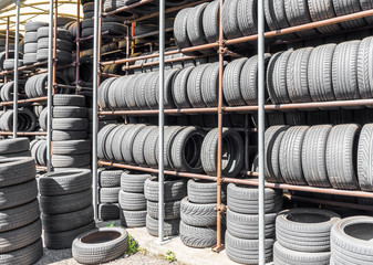 Stack of used tires in a car garage of installation service.