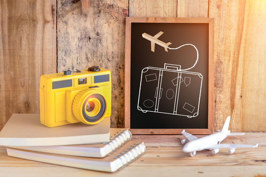 travel concept with drawing of suitcase on chalkboard