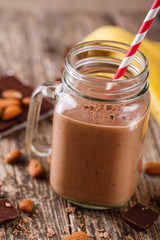 Detox chocolate smoothie with nuts in glass jar.