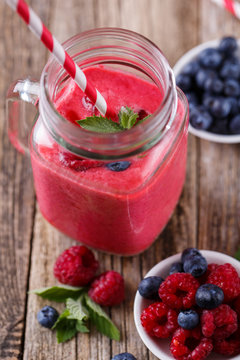 Healthy smoothie with raspberries, berries on plates and drinkin