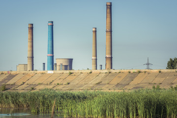 Factory with tall chimneys. Power plant chimneys tower in Bucharest city, view from Vacaresti...