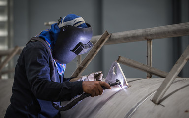 close up of technician welding metal pipe with argon,focus flash