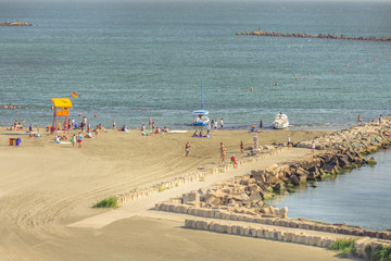 Fototapeta premium People resting on beach on in Mamaia, Romania. Mamaia is the largest and best known resort on Romanian Riviera. It's situated on 8km long and 300m wide sandy land strip at the Black Sea.