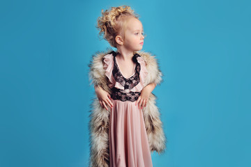 little girl in a long dress and a fur coat