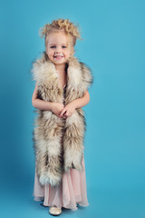 little girl in a long dress and a fur coat