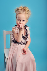little girl in a long dress and a fur coat