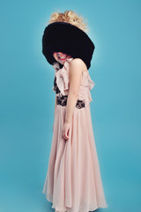 Naklejka premium little girl in a long dress and a fur coat