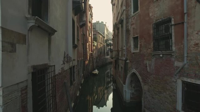VENICE, ITALY - JUNE 19, 2016: Walking through the streets of Venice with small canals and ancient buildings views. Venice, Italy.