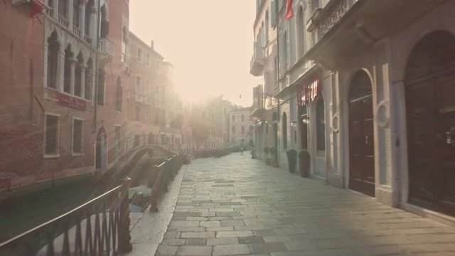VENICE, ITALY - JUNE 19, 2016: Walking through the streets of Venice with small canals and ancient buildings views. Venice, Italy.