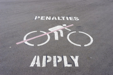 Penalties apply and no cycling sign on the road