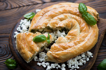 Close-up of sliced burekas pie with cheese and spinach