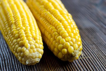 Fresh sweet corn on wooden table. Selective focus.