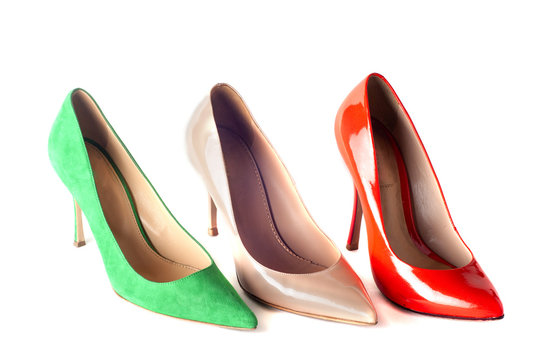 bright, multicolored female shoes on high heels isolated on whit