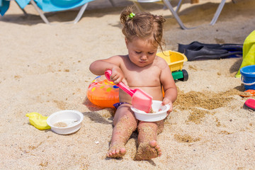 Little Girl Playing On The Beach