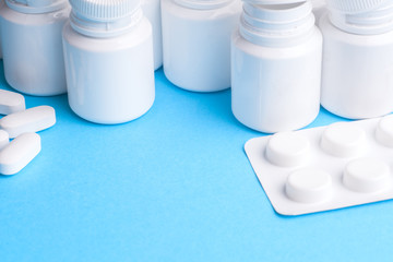 Many pills and tablets isolated on light blue background