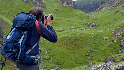 Man taking images of the beautiful scottish landscape