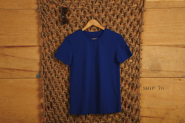 Blue basic cotton t-shirt presented in rustic interior