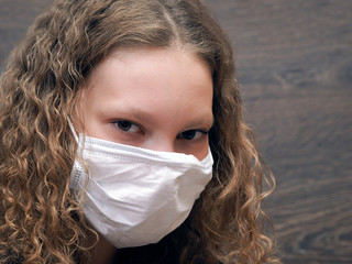 Portrait of a young girl in a medical mask. Concept - protection from infection and viruses, asthma, pollution