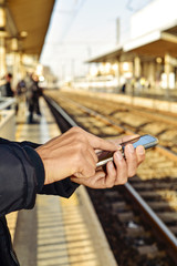 young man using a smartphone in a train station © nito