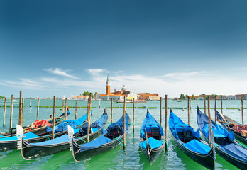 Fototapeta na wymiar A row of gondolas parked beside the Riva degli Schiavoni, Venice