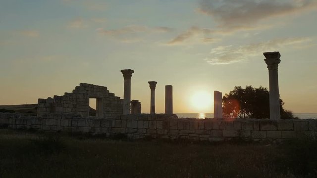 Ancient Greek basilica and marble columns in Chersonesus Taurica on the sunset background.