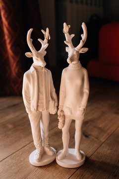 statue of a man-woman-deer and deer. rings on the horns. husband and zhena.zhenih and groom