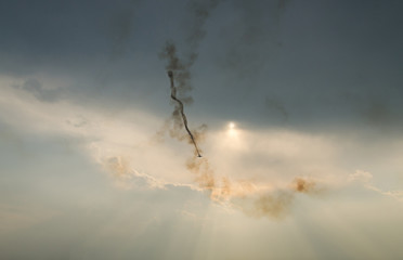 Airplane with colored trace smoke flying in the blue clouds sky, aerobatic stunt show