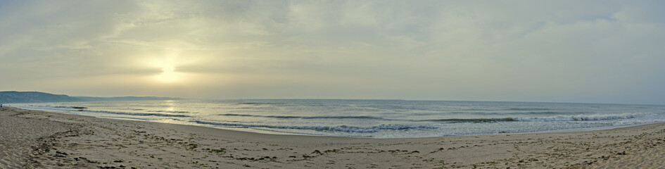 Sunrise on seaside, sand and clear water, the shore of Black Sea