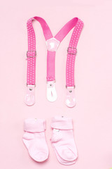 Cotton baby socks for newborn on a colorful pink background. Copy space for text. Top view