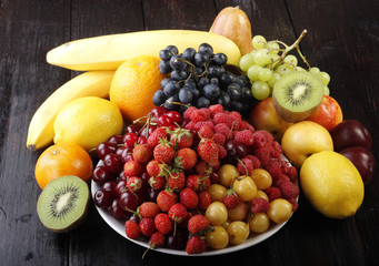 fruits and berries on wooden background